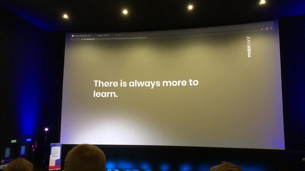 Photo from the Mobiconf conference. Visible screen of the lecture. On the slide, the inscription: There is always more to learn.