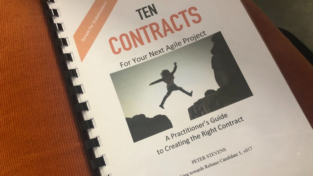 A book - promotional material after the conference: Ten Contracts for your Next Agile Project. A practicioner's Guide to Creating the Right Contract. - Peter Stevens. On the cover there is a person jumping the abyss.